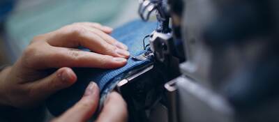 Close-Up Of Hand Holding Fabric.