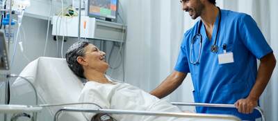 A nurse is attending to a patient.