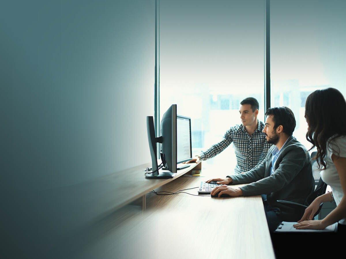 People looking at a monitor together