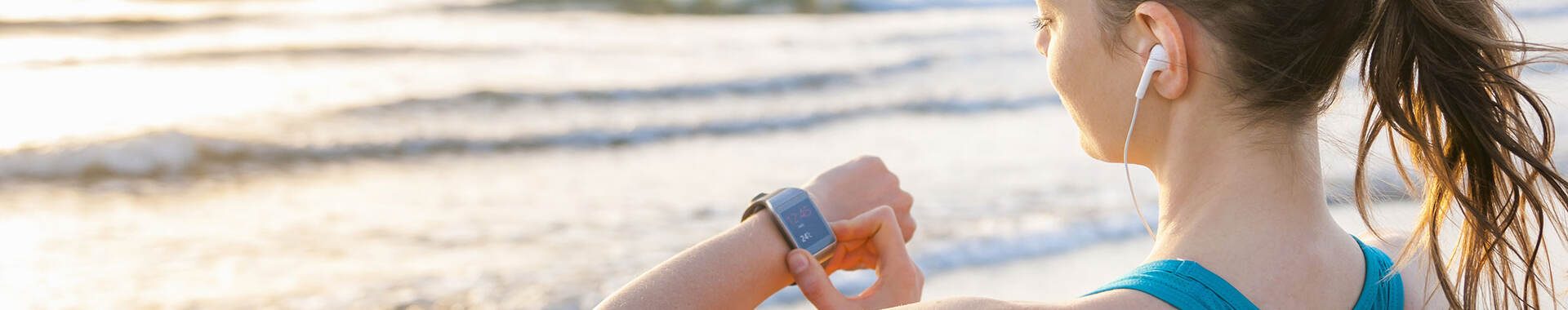 woman working out, looking at smartwatch