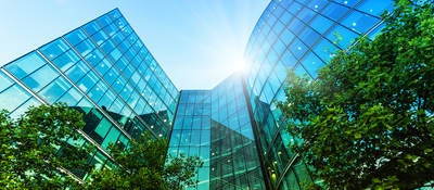 Modern skyscrapers and lush trees