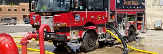 A parked fire truck receiving maintenance.