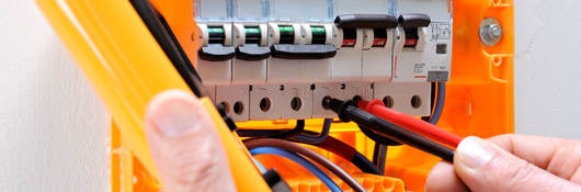 Electrician technician at work on a residential electric panel