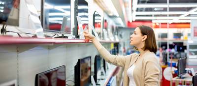 woman buying a TV in a retail store