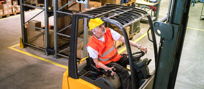 Worker driving a forklift