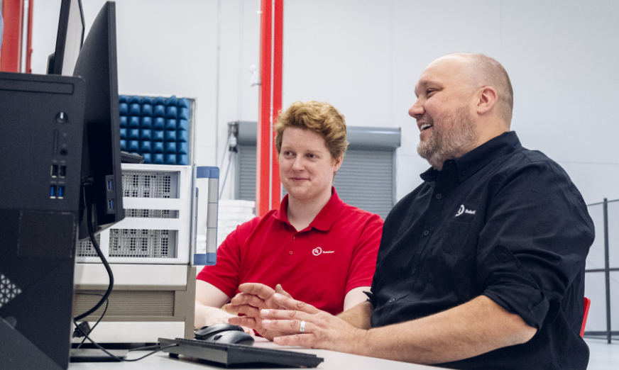 Two UL Solutions employees looking at a computer monitor