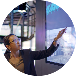 Person touching a large screen displaying windfarm data